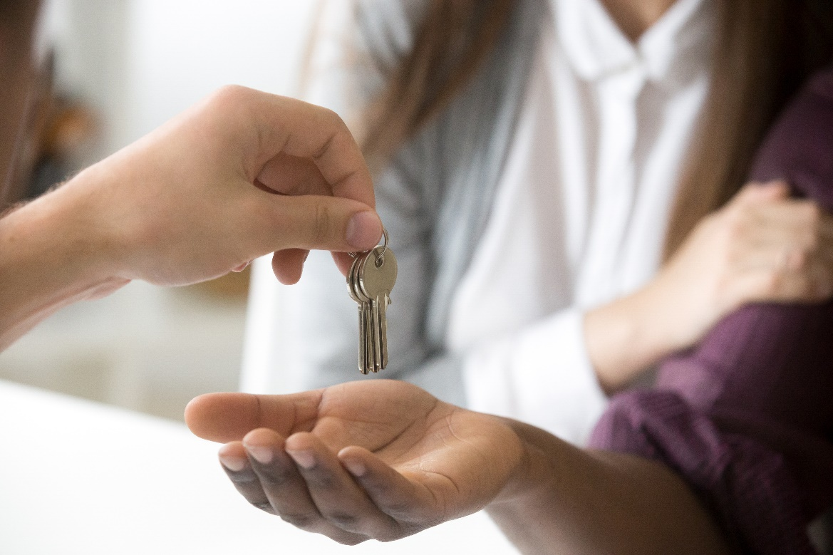 Real estate agent handing over home keys